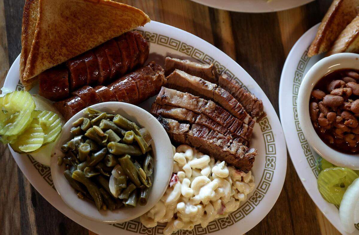 The combo plate featuring sausage and brisket at Hickory Stick Barbecue in Everman on Tuesday, June 27, 2023. Hickory Stick Barbecue was voted best barbecue in the Fort Worth Star-Telegram’s Readers’ Choice.